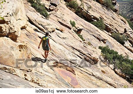Young female rock climber croossing steep rockface, Mount Wilson, Nevada, USA View Large Photo Image Stock Image - Young female rock climber croossing steep rockface, Mount Wilson, Nevada, USA. Fotosearch