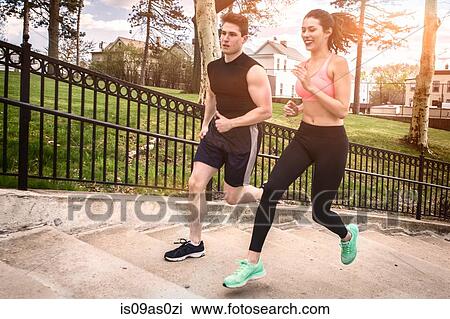 Young male and female runners running up park stairway View Large Photo Image Stock Image - Young male and female runners running up park stairway. Fotosearch