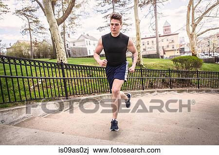 Young male runner running up park stairway View Large Photo Image Stock Image - Young male runner running up park stairway. Fotosearch