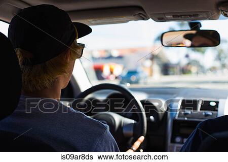 Stock Photograph - Young man behind wheel of car. Fotosearch