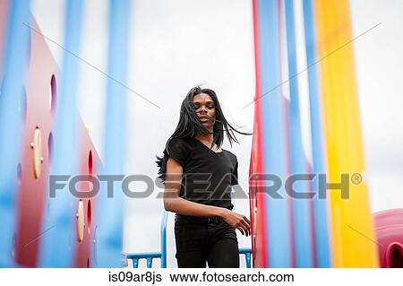 Young man with long hair in playground View Large Photo Image Stock Photograph - Young man with long hair in playground. Fotosearch