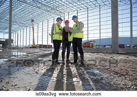 Stock Image - Architect and builders meeting on construction site. Fotosearch