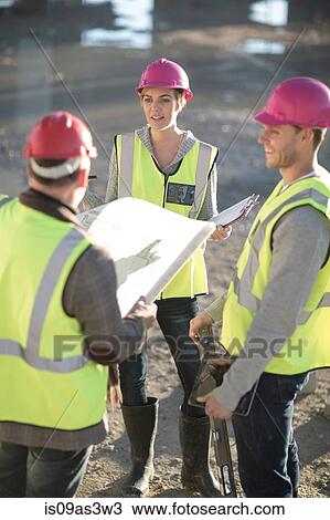 Architect and surveyors with blueprint on construction site View Large Photo Image Stock Image - Architect and surveyors with blueprint on construction site. Fotosearch