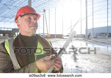 Stock Photo - Architect looking up on construction site. Fotosearch
