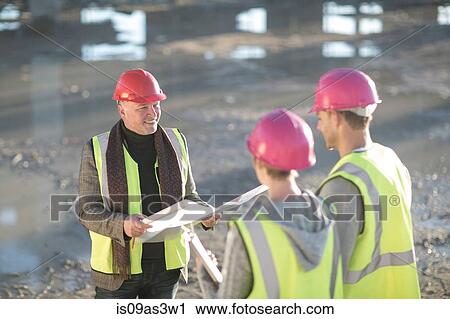 Architect meeting with builders on construction site View Large Photo Image Stock Image - Architect meeting with builders on construction site. Fotosearch