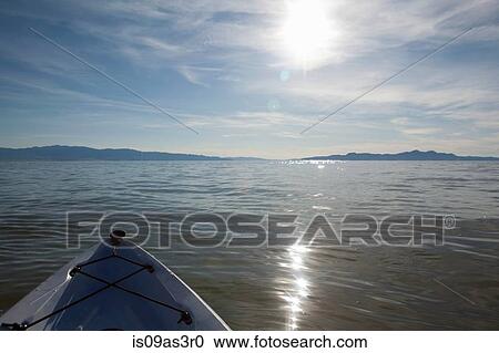 Stock Image - Bow of kayak with sunlight reflecting on water, Great Salt Lake, Utah, USA. Fotosearch