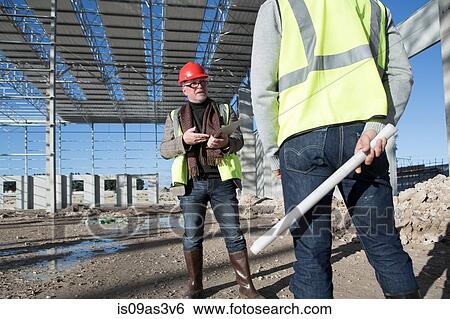 Builder and architect meeting on construction site View Large Photo Image Stock Photograph - Builder and architect meeting on construction site. Fotosearch