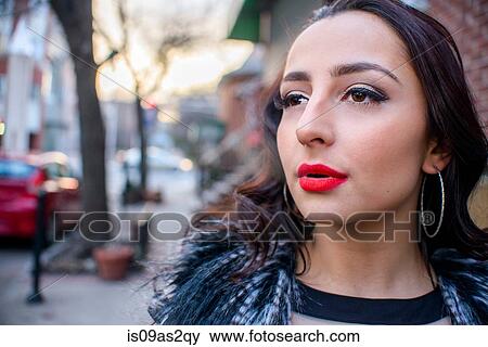 Stock Photo - Close up of glamorous young woman on street wearing red lipstick. Fotosearch