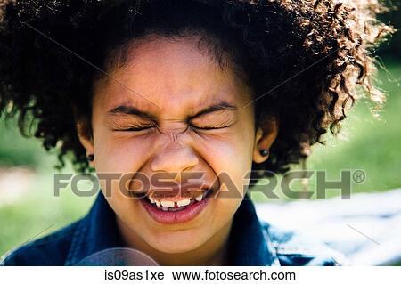 Close up portrait of girl with eyes closed pulling face View Large Photo Image Stock Image - Close up portrait of girl with eyes closed pulling face. Fotosearch