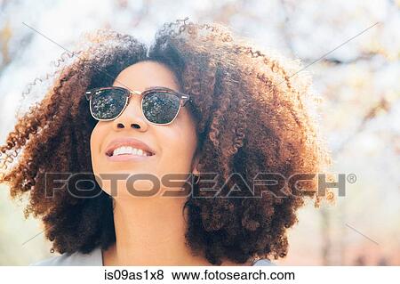 Close up portrait of mid adult woman, wearing sunglasses, smiling, looking away View Large Photo Image Stock Photo - Close up portrait of mid adult woman, wearing sunglasses, smiling, looking away. Fotosearch