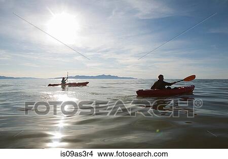 Picture - Couple kayaking, sunlight reflecting on water, Great Salt Lake, Utah, USA. Fotosearch