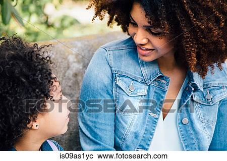 Cropped view of mother and daughter sitting face to face View Large Photo Image Stock Image - Cropped view of mother and daughter sitting face to face. Fotosearch