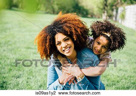Daughter standing behind mother, arms around neck, smiling View Large Photo Image Stock Image - Daughter standing behind mother, arms around neck, smiling. Fotosearch