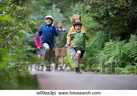 Stock Image - Family exploring woods, Winner Creek, Alyeska Resort, Turnagain Arm, Mt. Alyeska, Girdwood, Alaska, USA. Fotosearch