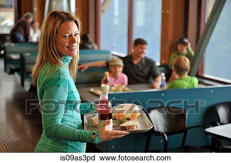 Stock Image - Family taking a break from hiking, Glacier Express Restaurant, Upper Tram Terminal, Alyeska Resort, Mt. Alyeska, Girdwood, Alaska, USA. Fotosearch