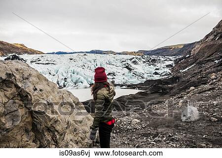Female tourist pointing at glacier at Solheimajokull, Iceland View Large Photo Image Stock Image - Female tourist pointing at glacier at Solheimajokull, Iceland. Fotosearch