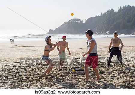 Four adult friends playing with ball on Short Sands Beach, Oregon, USA View Large Photo Image Stock Image - Four adult friends playing with ball on Short Sands Beach, Oregon, USA. Fotosearch