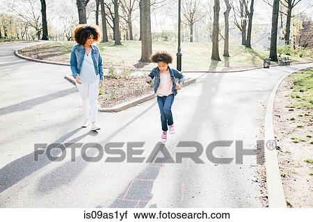 Front view of mother and daughter playing hopscotch View Large Photo Image Stock Image - Front view of mother and daughter playing hopscotch. Fotosearch