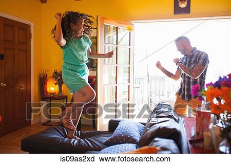 Girl and father dancing in living room View Large Photo Image Stock Image - Girl and father dancing in living room. Fotosearch
