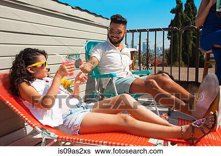 Girl and her father toasting with juice drink on patio View Large Photo Image Stock Photograph - Girl and her father toasting with juice drink on patio. Fotosearch