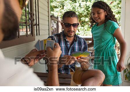 Girl watching father and his brother play cards in porch View Large Photo Image Picture - Girl watching father and his brother play cards in porch. Fotosearch