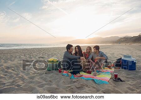 Group of friends having picnic on beach View Large Photo Image Stock Image - Group of friends having picnic on beach. Fotosearch