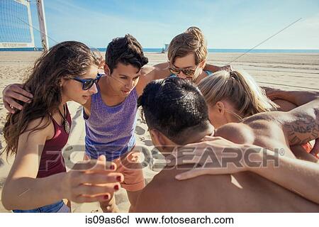 Group of friends in huddle on beach View Large Photo Image Stock Image - Group of friends in huddle on beach. Fotosearch