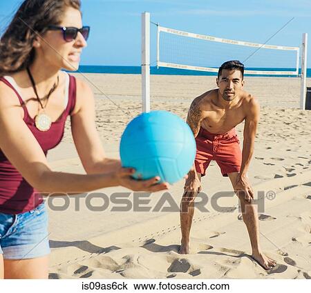 Group of friends playing volleyball on beach View Large Photo Image Stock Image - Group of friends playing volleyball on beach. Fotosearch
