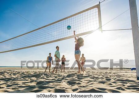 Group of friends playing volleyball on beach View Large Photo Image Stock Photograph - Group of friends playing volleyball on beach. Fotosearch