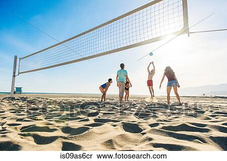 Group of friends playing volleyball on beach View Large Photo Image Stock Photography - Group of friends playing volleyball on beach. Fotosearch