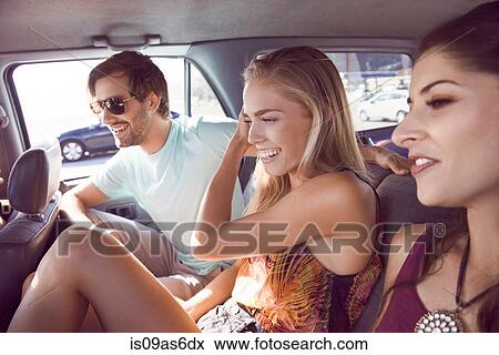 Group of friends sitting in car, laughing View Large Photo Image Stock Photo - Group of friends sitting in car, laughing. Fotosearch