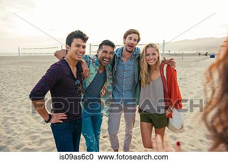 Group of friends standing together on beach, laughing View Large Photo Image Stock Image - Group of friends standing together on beach, laughing. Fotosearch