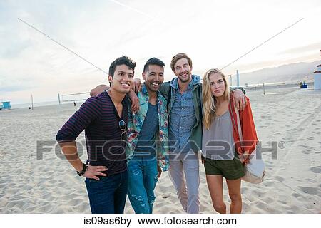 Group of friends standing together on beach, laughing View Large Photo Image Stock Photo - Group of friends standing together on beach, laughing. Fotosearch