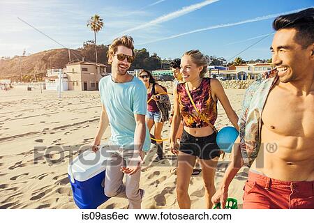 Group of friends walking on beach, ready for picnic View Large Photo Image Stock Image - Group of friends walking on beach, ready for picnic. Fotosearch