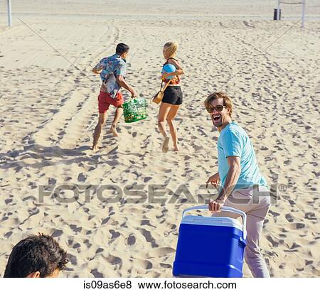 Group of friends walking on beach, ready for picnic View Large Photo Image Stock Photo - Group of friends walking on beach, ready for picnic. Fotosearch