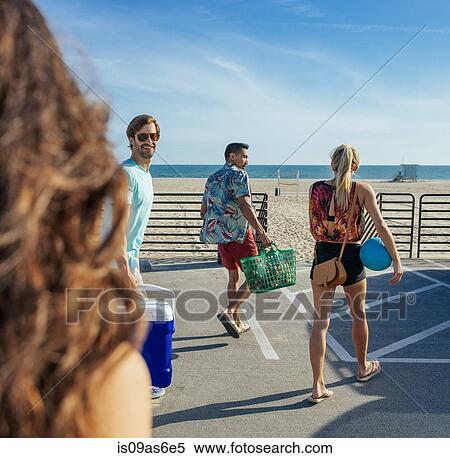 Stock Photography - Group of friends, walking towards beach. Fotosearch