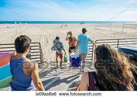 Group of friends, walking towards beach, rear view View Large Photo Image Stock Photograph - Group of friends, walking towards beach, rear view. Fotosearch