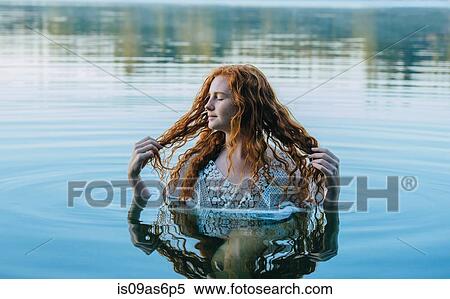 Head and shoulders of beautiful young woman with long red hair in lake View Large Photo Image Stock Photography - Head and shoulders of beautiful young woman with long red hair in lake. Fotosearch