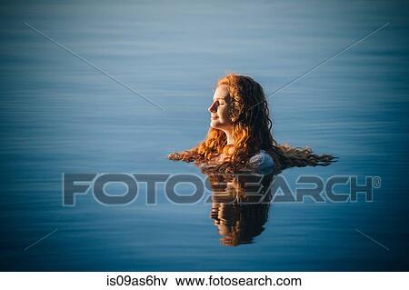 Head and shoulders of young woman with long red hair in lake with eyes closed View Large Photo Image Stock Photo - Head and shoulders of young woman with long red hair in lake with eyes closed. Fotosearch