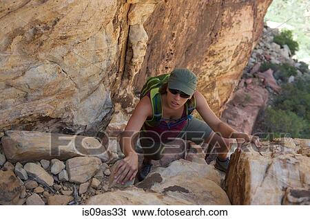 High angle view of hiker climbing up rocks looking up at camera View Large Photo Image Stock Photograph - High angle view of hiker climbing up rocks looking up at camera. Fotosearch