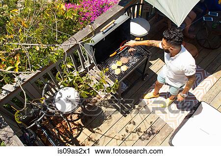 High angle view of mid adult man barbecuing View Large Photo Image Stock Image - High angle view of mid adult man barbecuing. Fotosearch