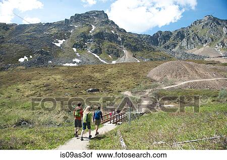 Stock Image - hikers exploring, Hatcher Pass, Matanuska Valley, Palmer, Alaska, USA. Fotosearch
