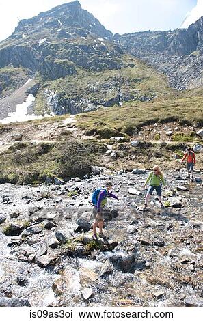 Stock Image - hikers exploring, Hatcher Pass, Matanuska Valley, Palmer, Alaska, USA. Fotosearch