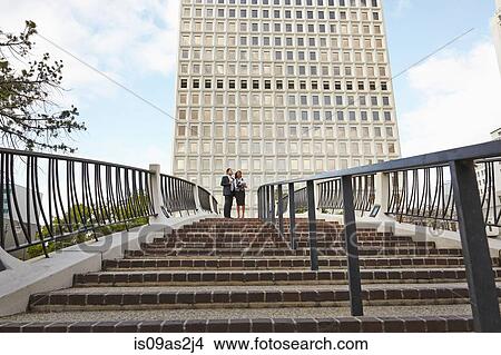 Picture - Low angle view of business people standing at top of stairway, City Hall East, Los Angeles, California, USA. Fotosearch