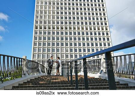 Low angle view of business people standing at top of stairway, City Hall East, Los Angeles, California, USA View Large Photo Image Stock Photo - Low angle view of business people standing at top of stairway, City Hall East, Los Angeles, California, USA. Fotosearch