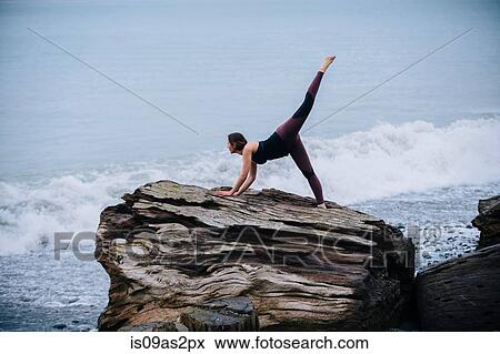 Mature woman practicing yoga on large driftwood tree stump on beach View Large Photo Image Stock Photo - Mature woman practicing yoga on large driftwood tree stump on beach. Fotosearch