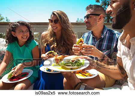 Mid adult family and daughter eating barbecue food in garden View Large Photo Image Stock Photography - Mid adult family and daughter eating barbecue food in garden. Fotosearch