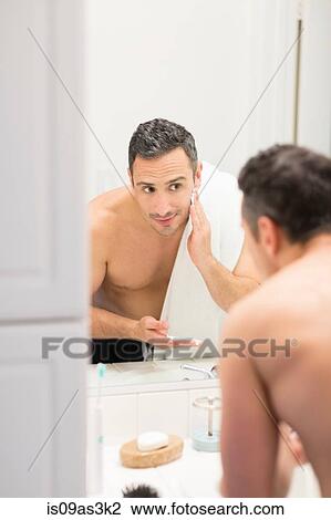 Mid adult man, looking in mirror, applying shaving foam to face, rear view View Large Photo Image Stock Image - Mid adult man, looking in mirror, applying shaving foam to face, rear view. Fotosearch