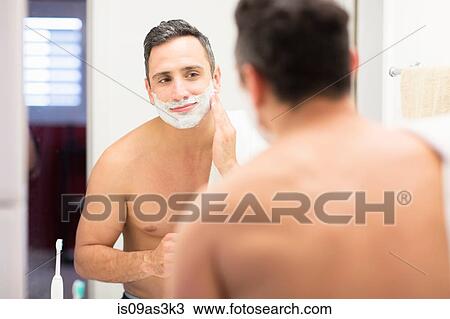 Mid adult man, looking in mirror, applying shaving foam to face, rear view View Large Photo Image Stock Image - Mid adult man, looking in mirror, applying shaving foam to face, rear view. Fotosearch
