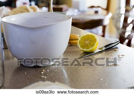 Picture - Mixing bowl and halved lemon. Fotosearch